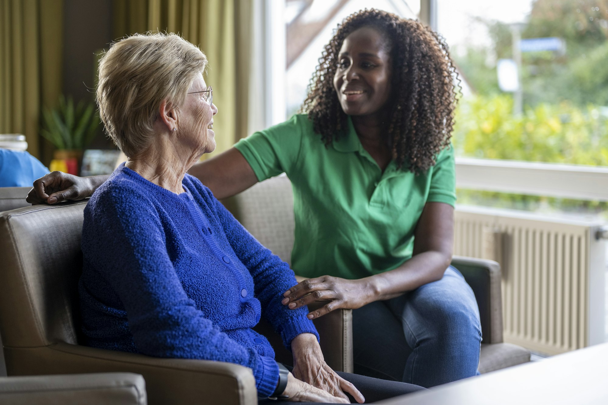 Helper caring for elderly lady